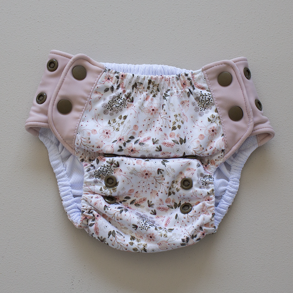 Kekoa flexible stretch wing swim nappy in Wild Meadow print. From 4-19kg (9lbs - 42lbs) in a one size OSFM design.