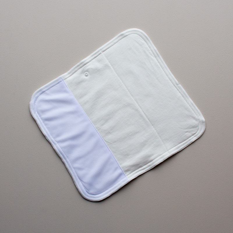 Kekoa cloth nappy showing small bamboo cotton trifold insert open flat top flexible stretch wings stay dry panel and lead free